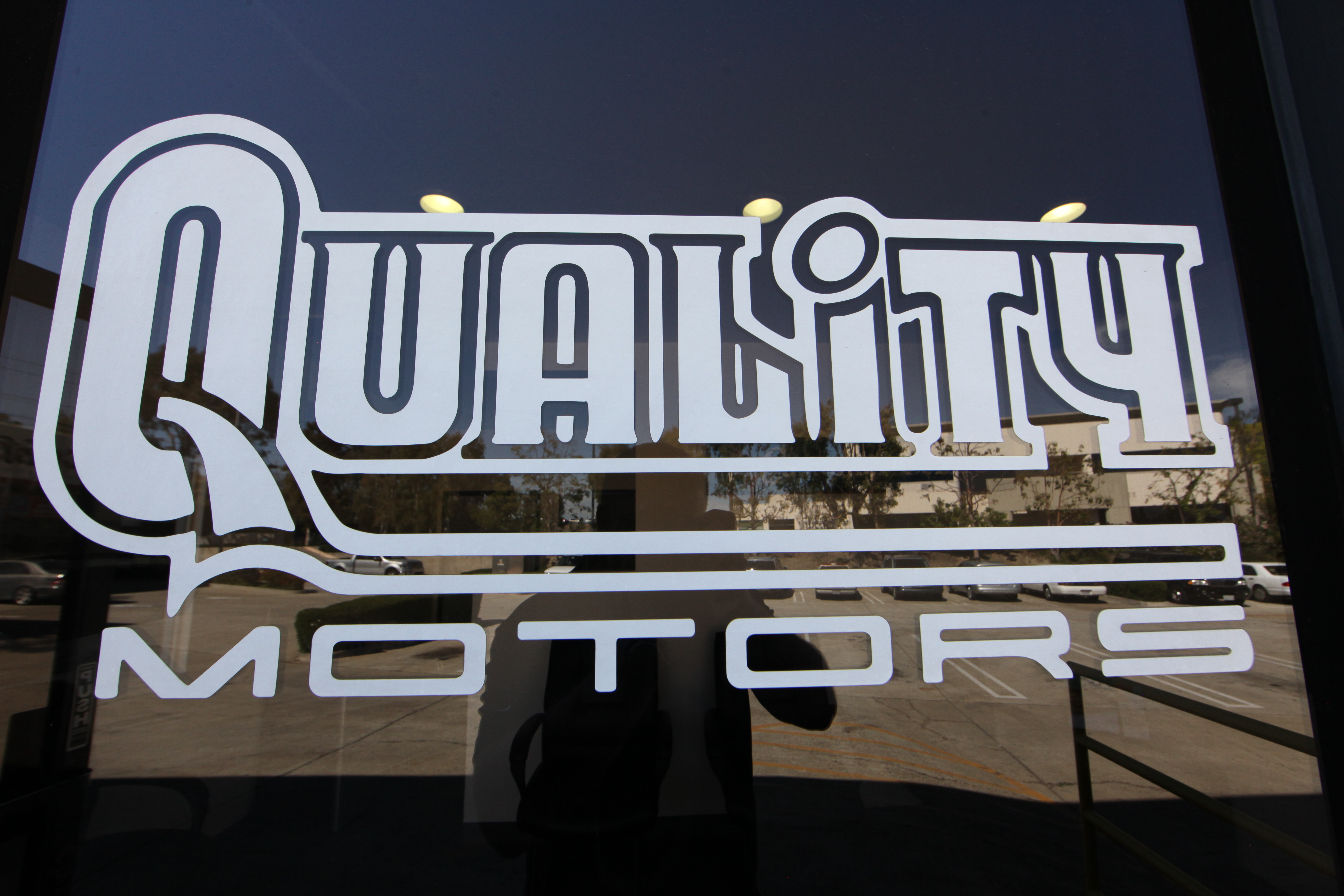 Quality Motors Door Logo